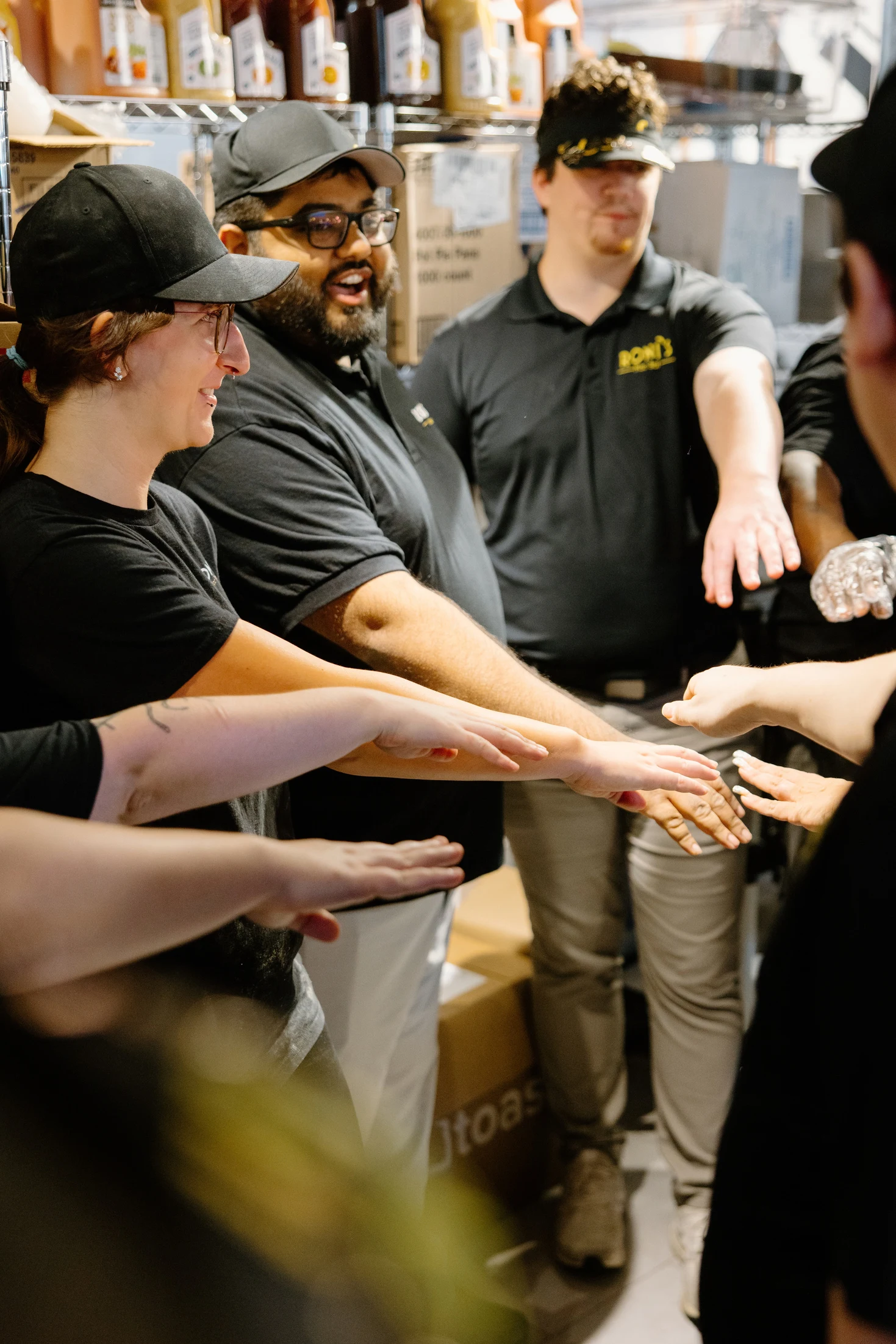 Roni’s team members gathering for a team huddle