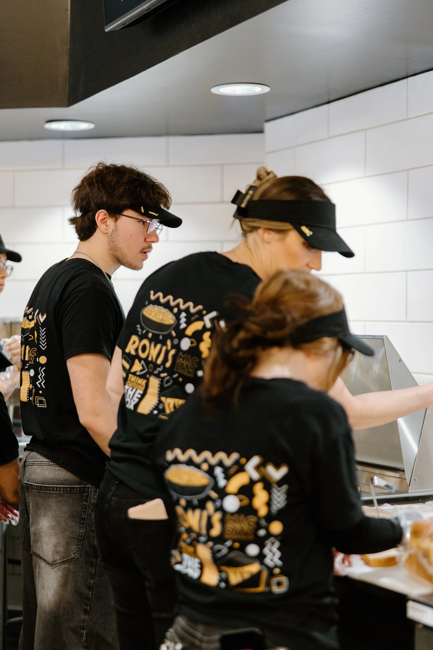 Roni’s team members preparing orders together in the kitchen